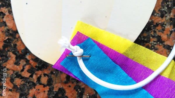 carnival mask for kindergarten craft - attaching elastic