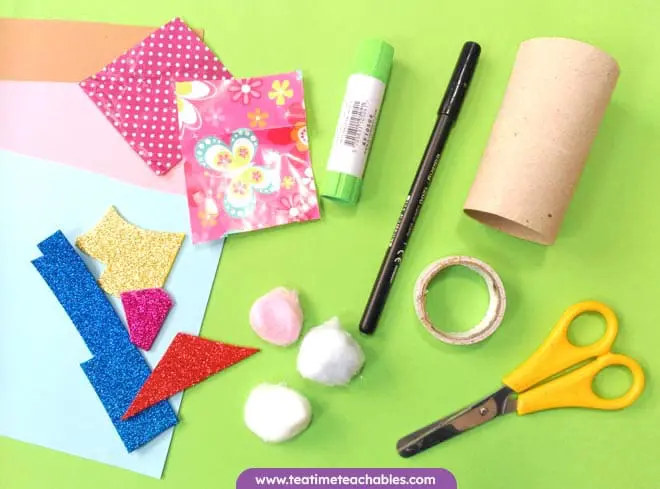 Craft supplies for the rabbit craft for kids. Includes scissors, glue, colored paper, glitter card and cotton balls. 