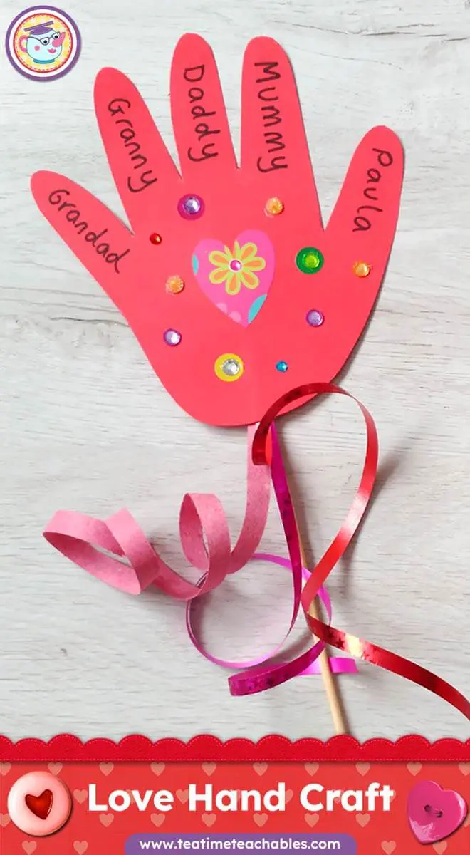 Red paper handprint craft decorated with colorful gems and a heart. Names like "Daddy" and "Mummy" are written on each finger. Ribbons are attached. It’s an easy Valentine’s Day Craft for kids. 